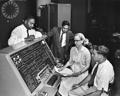 Grace Hopper sitting in front of the UNIVAC, which she helped develop.